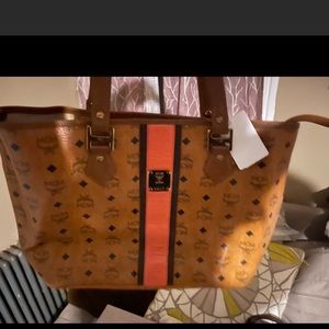 Authenticated cognac and orange MCM brand